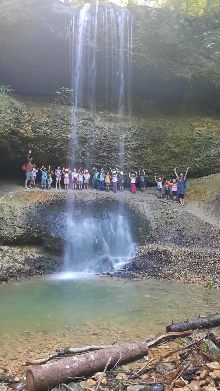 Kinder hinter einem Wasserfall